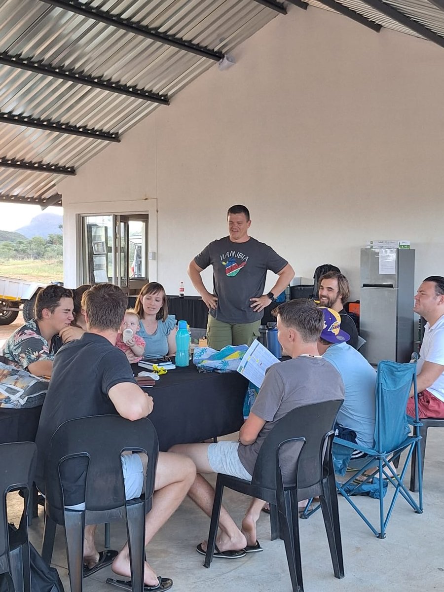 Francois sharing a conversation with a group around a table