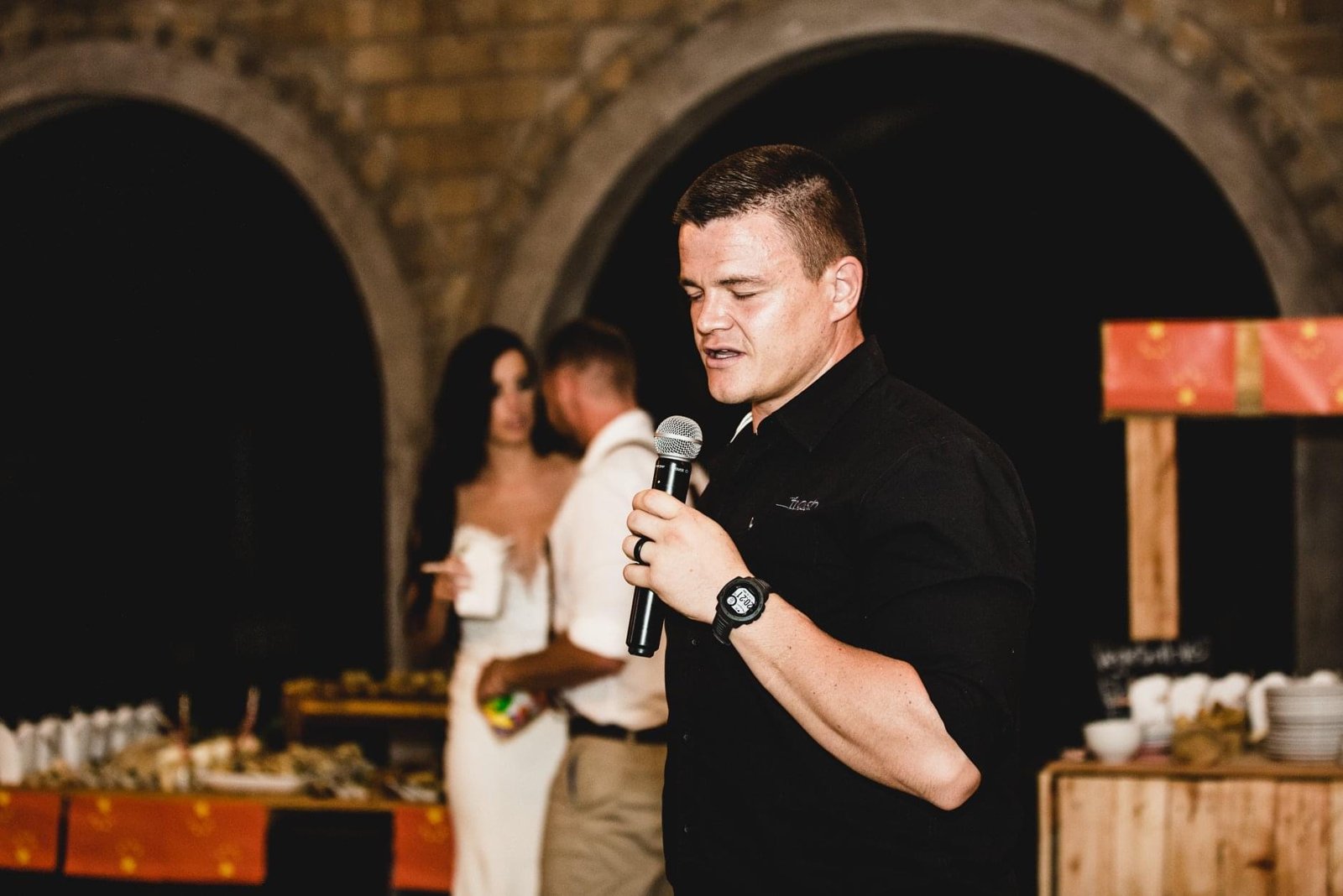Francois speaking into a microphone at a gathering